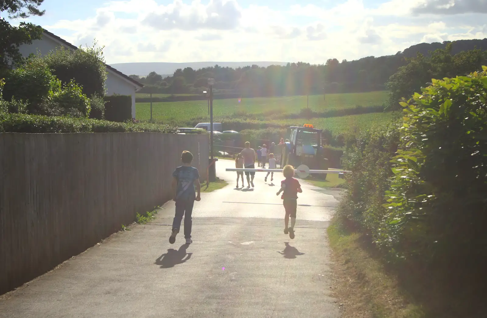 Rowan and Fred run down to catch the tractor ride, from Camping With Sean, Ashburton, Devon - 8th August 2016