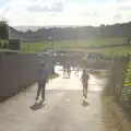 Rowan and Fred run down to catch the tractor ride, Camping With Sean, Ashburton, Devon - 8th August 2016