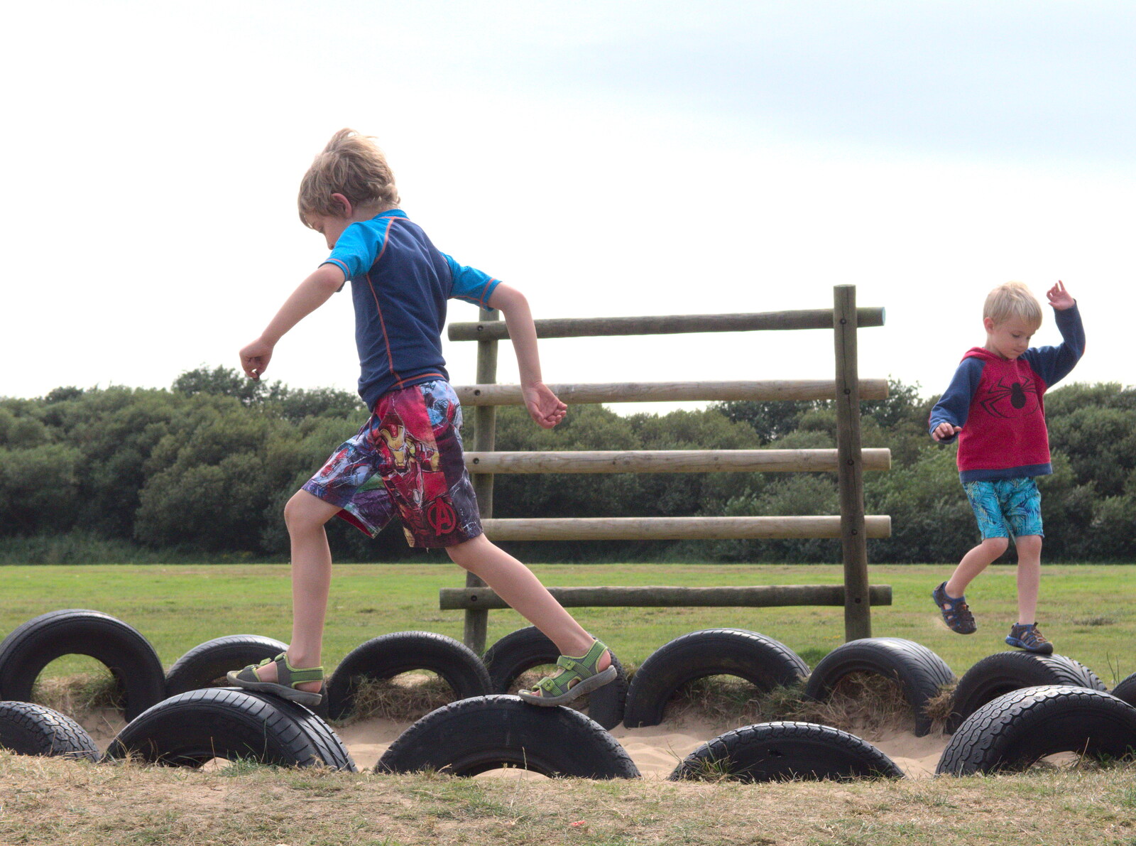 The boys run around the tyre ring from A Trip to Waxham Sands,  Horsey, Norfolk - 27th August 2016