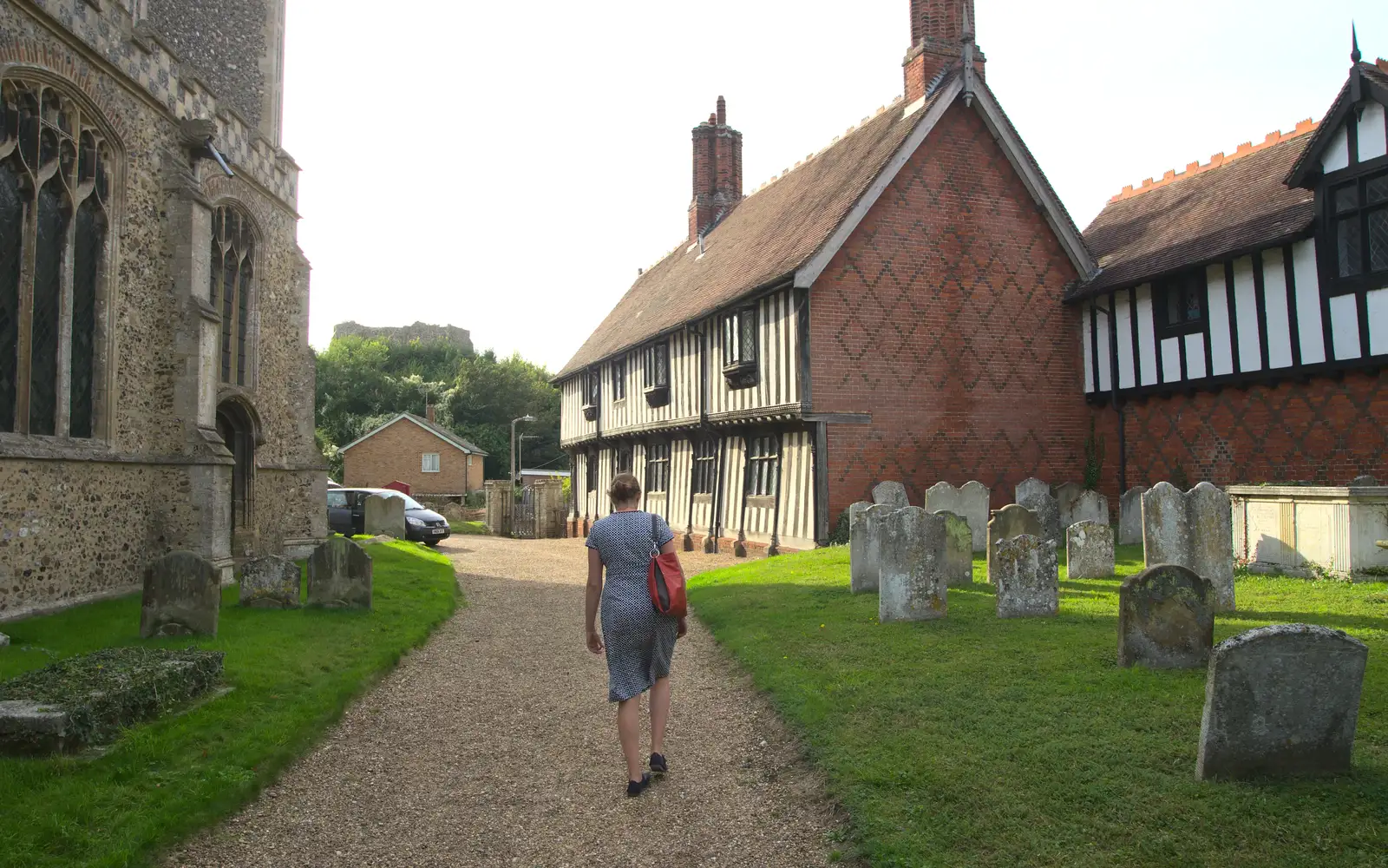 Isobel wanders back past the church, from The Eye Scouts Duck Race, The Pennings, Eye, Suffolk - 24th September 2016