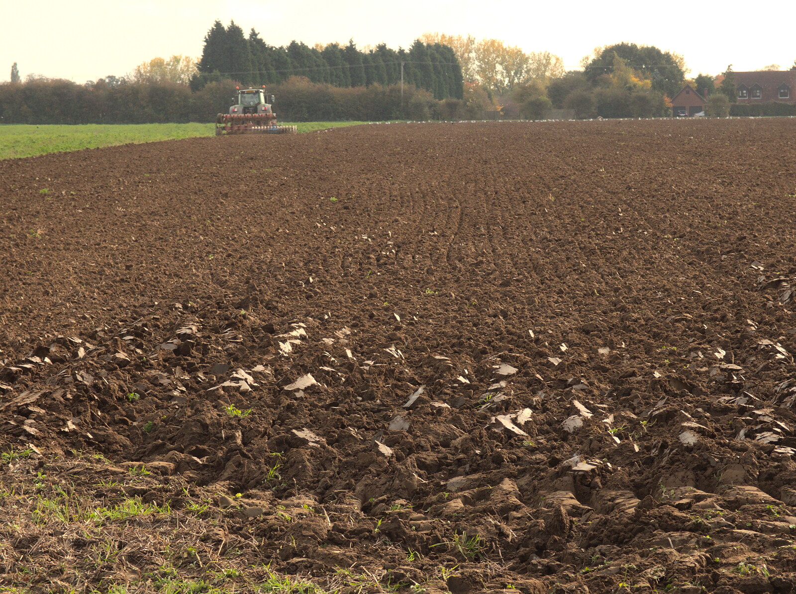 The tractor ploughs up the field from Tractor Rides and Pub Cellars, Brome, Suffolk - 29th October 2016