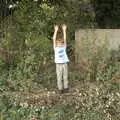 Fred sticks his hands up through the nettles, Tractor Rides and Pub Cellars, Brome, Suffolk - 29th October 2016