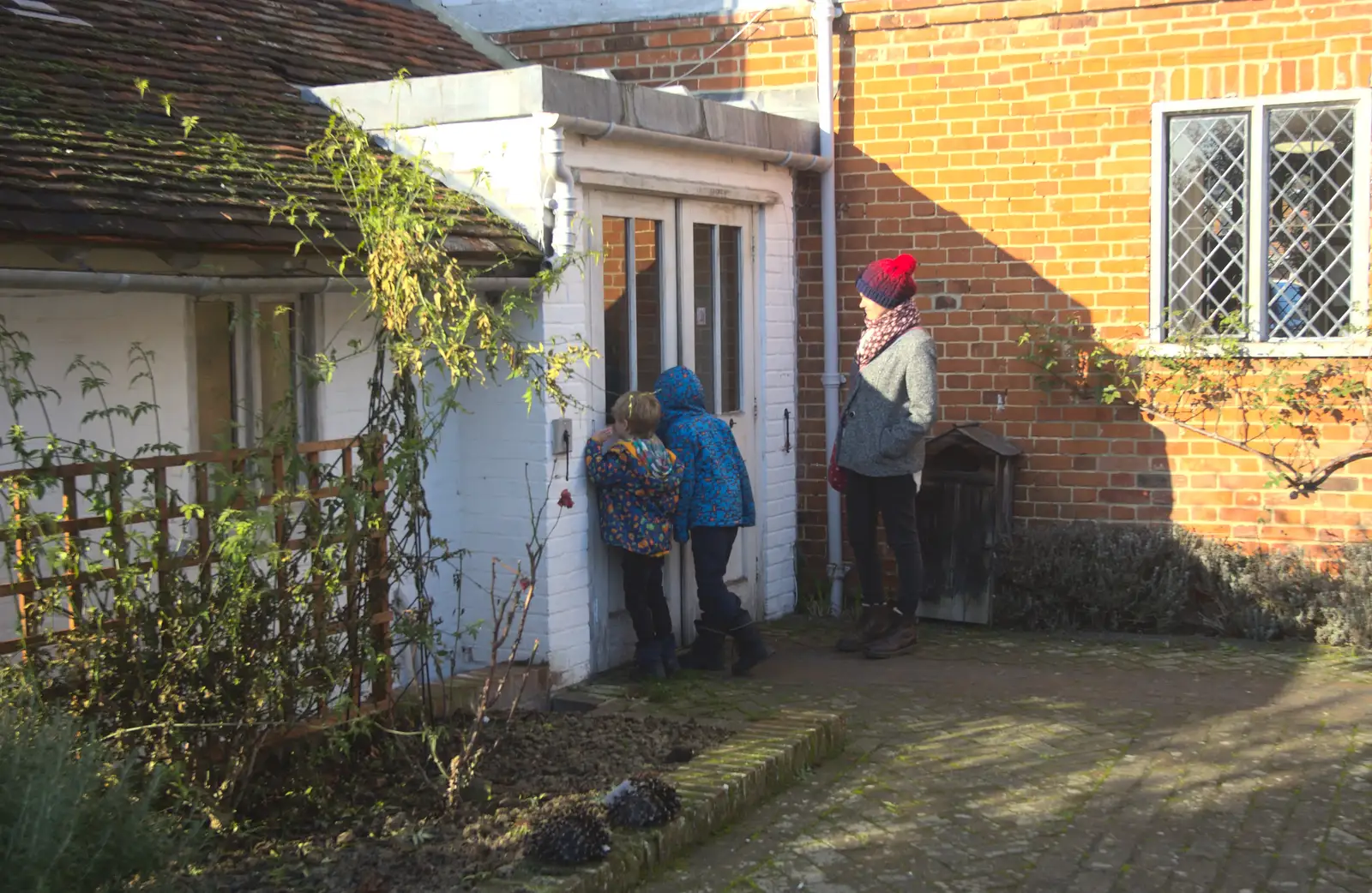 The boys peer into a door, from A Day in Lavenham, Suffolk - 22nd January 2017