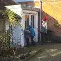 The boys peer into a door, A Day in Lavenham, Suffolk - 22nd January 2017