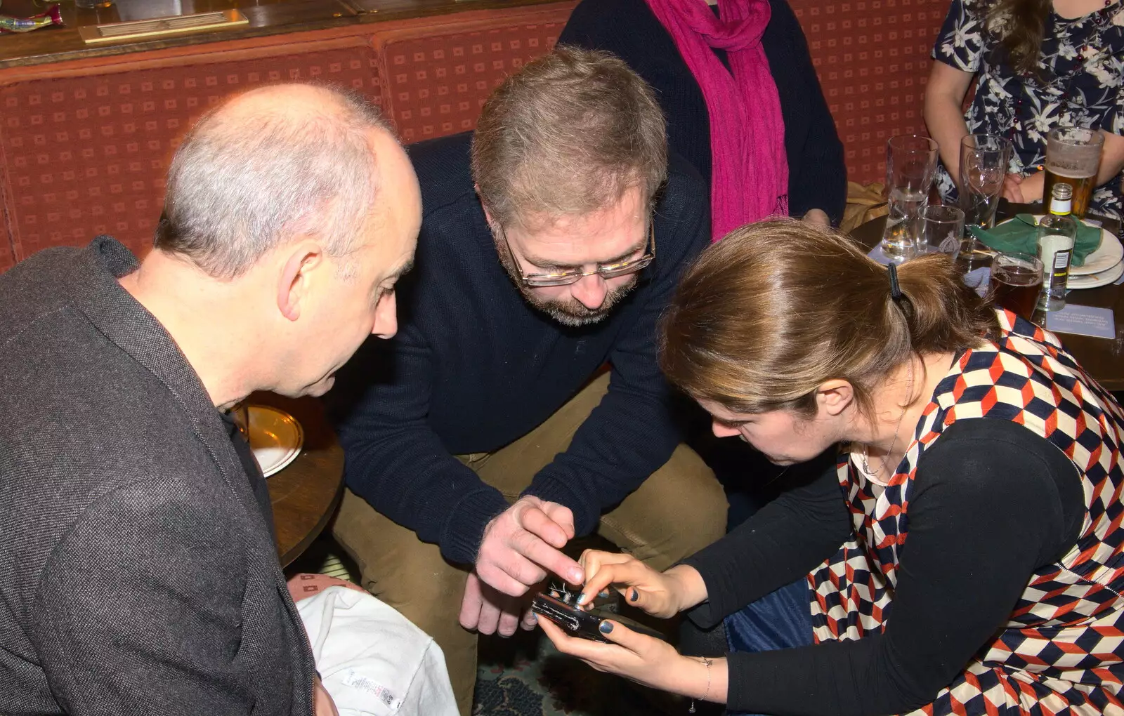 Isobel does something on a phone, from Sylvia's 70th Birthday up the Swan Inn, Brome, Suffolk - 11th February 2017