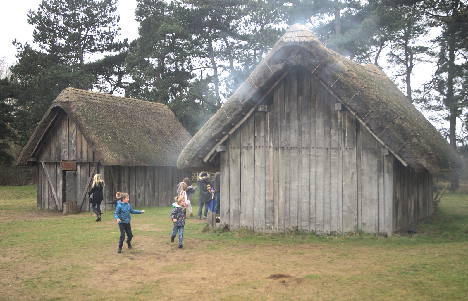 The boys run around a smoking house from An Anglo-Saxon Village, West Stow, Suffolk - 19th February 2017