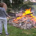 Isobel pokes a big bonfire with a stick, A Postcard from Beccles, Suffolk - 2nd April 2017