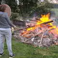 Isobel pokes a big bonfire with a stick, A Postcard from Beccles, Suffolk - 2nd April 2017