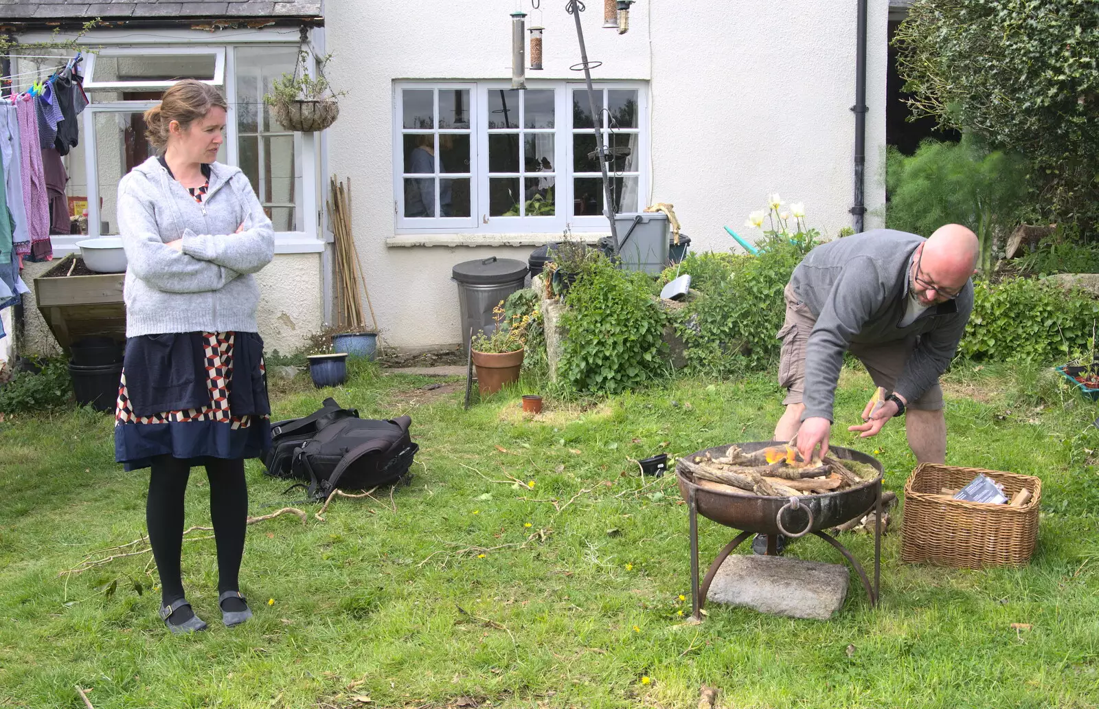 Isobel watches as stuff is set on fire, from A Barbeque, Grimspound and Pizza, Dartmoor and Exeter, Devon - 15th April 2017