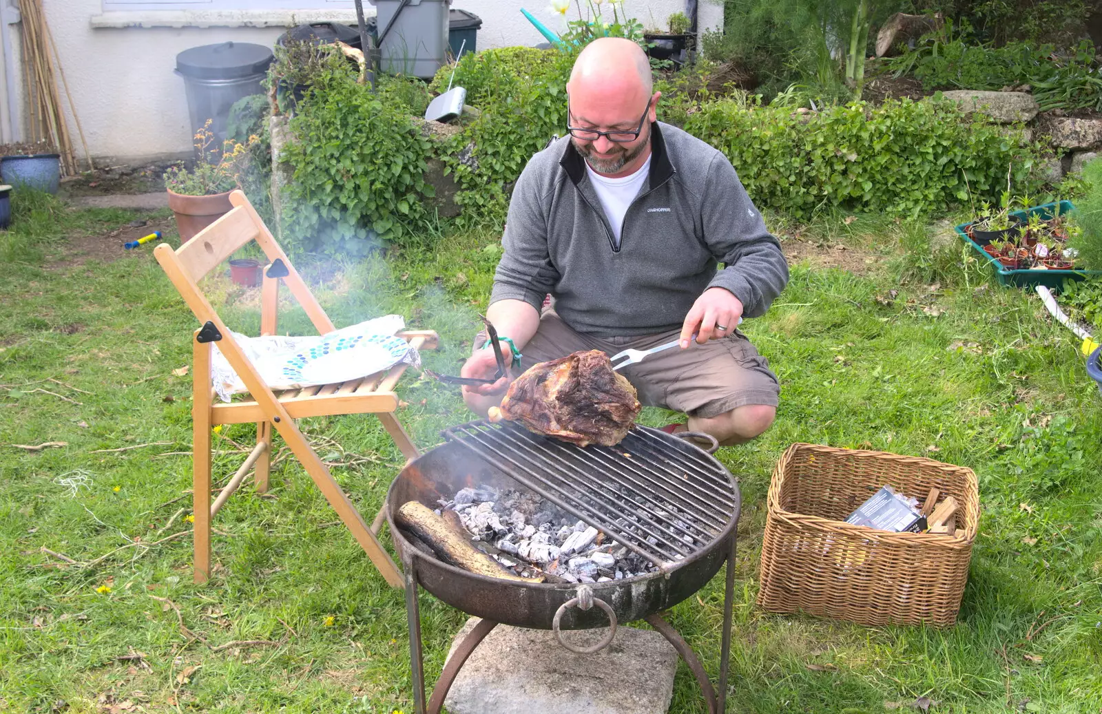 Matt sticks a massive lump of lamb on the fire, from A Barbeque, Grimspound and Pizza, Dartmoor and Exeter, Devon - 15th April 2017