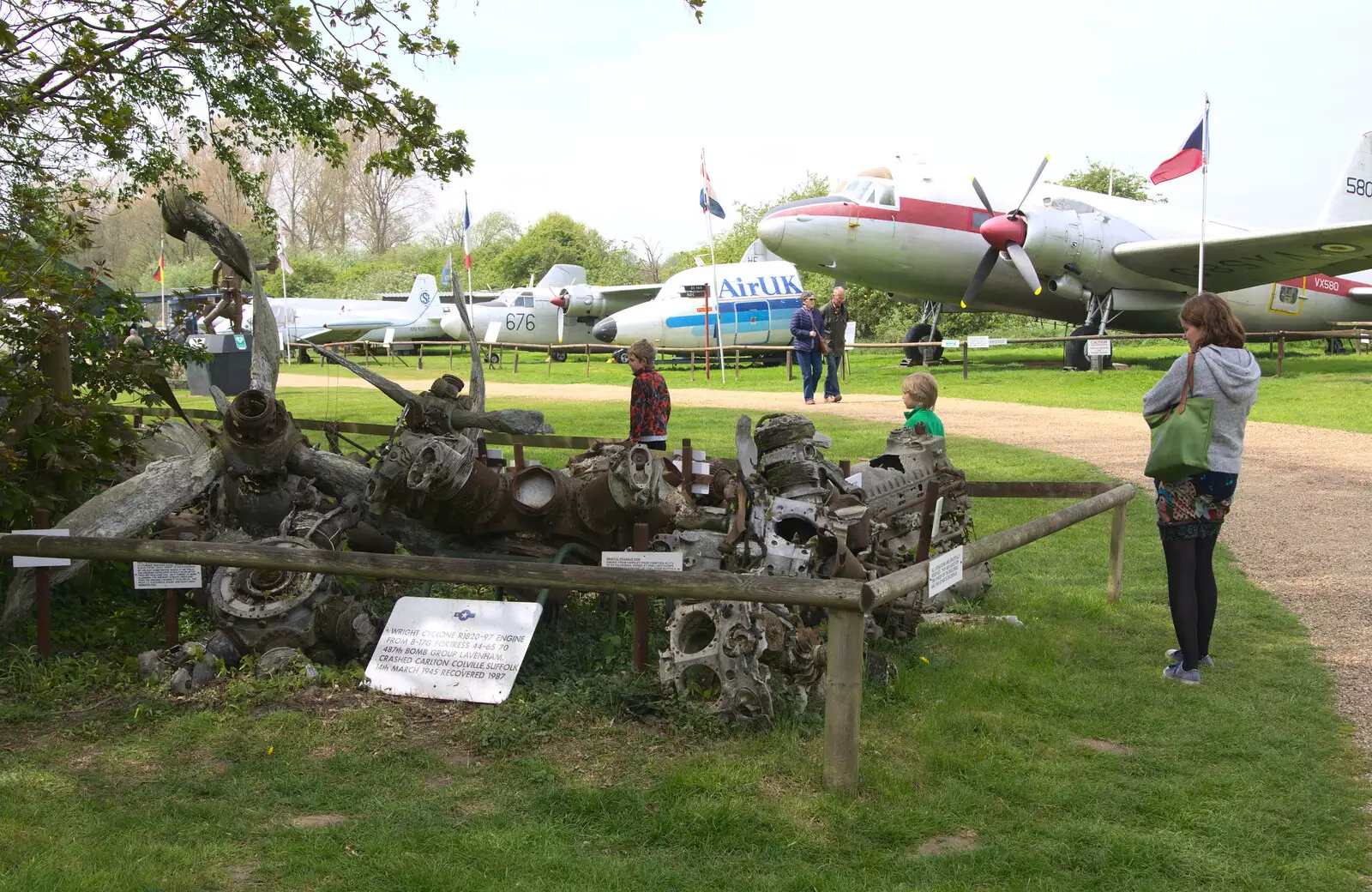 Isobel looks at a pile of wreckage, from Norfolk and Suffolk Aviation Museum, Flixton, Suffolk - 30th April 2017