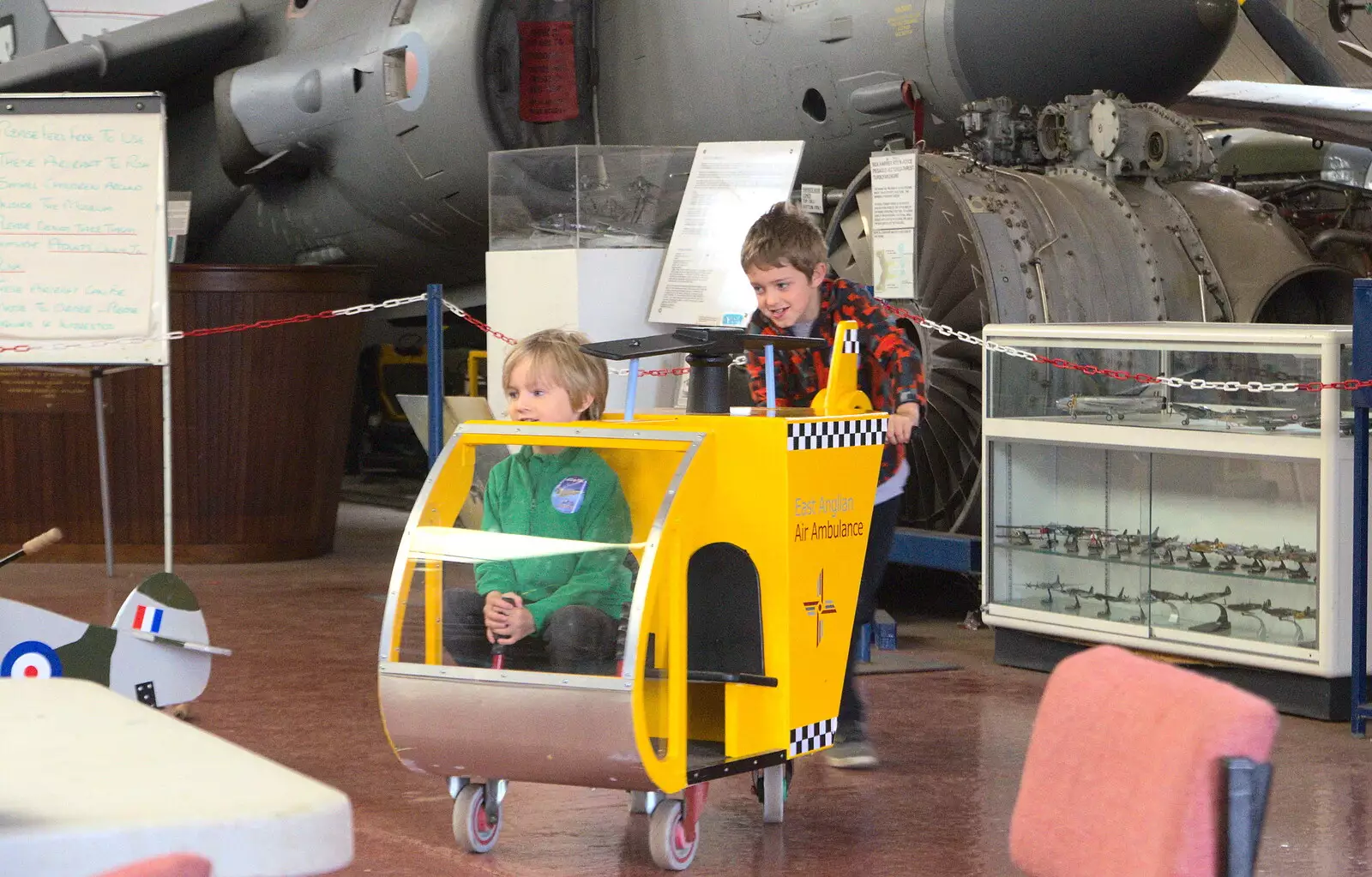 Fred pushes Harry around in a helicopter, from Norfolk and Suffolk Aviation Museum, Flixton, Suffolk - 30th April 2017