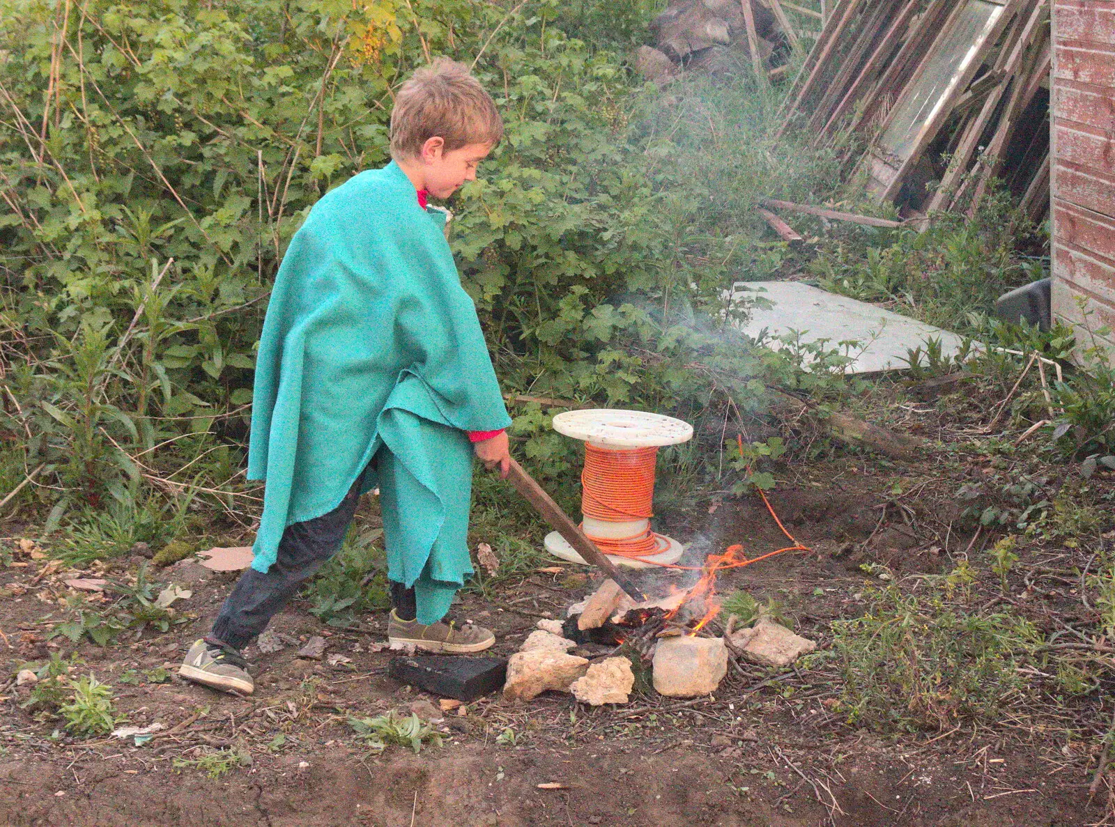 Fred pokes a fire with a stick, from Campfires, Oaksmere Building and a BSCC Bike Ride, Brome, Suffolk - 4th May 2017