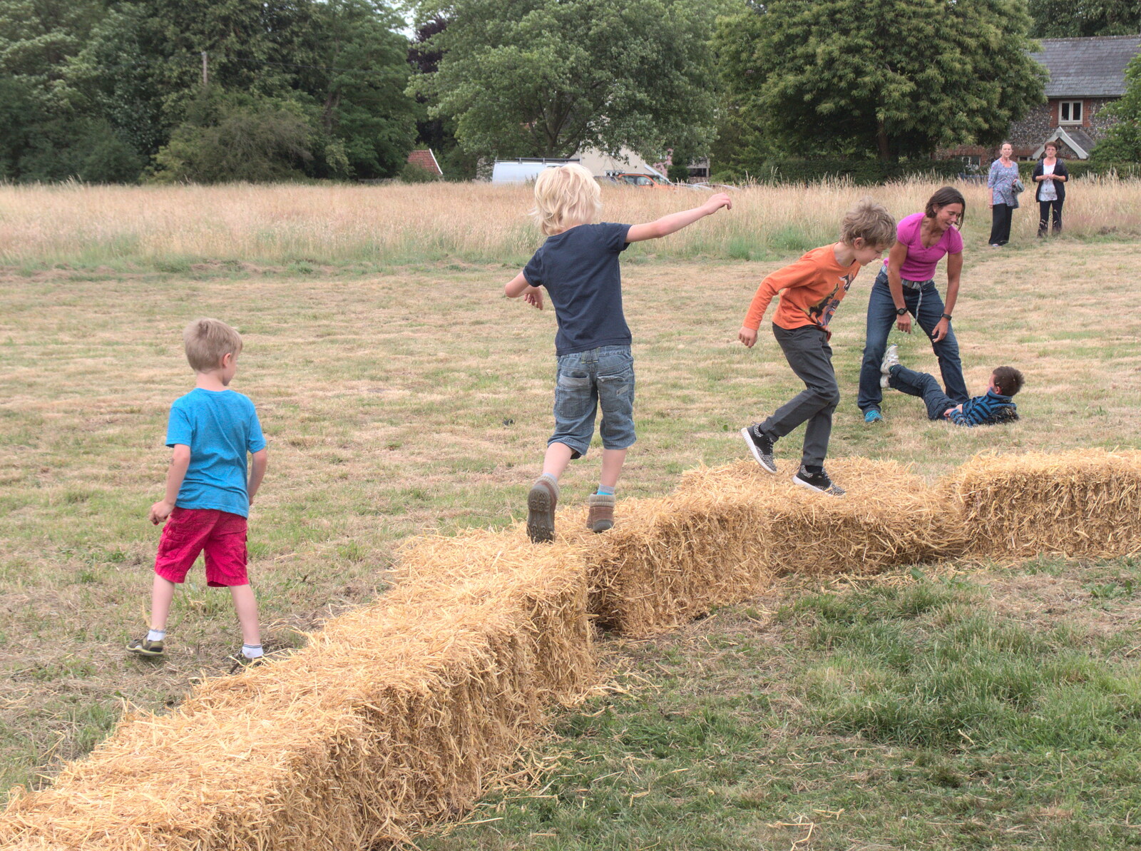 All the children are running on bales from Thrandeston Pig, Little Green, Thrandeston, Suffolk - 25th June 2017