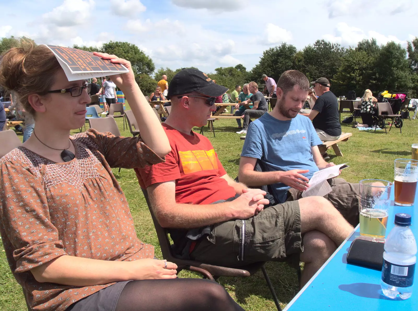 Suey uses the beer list as a sun shade, from The Humpty Dumpty Beer Festival, Reedham, Norfolk - 22nd July 2017