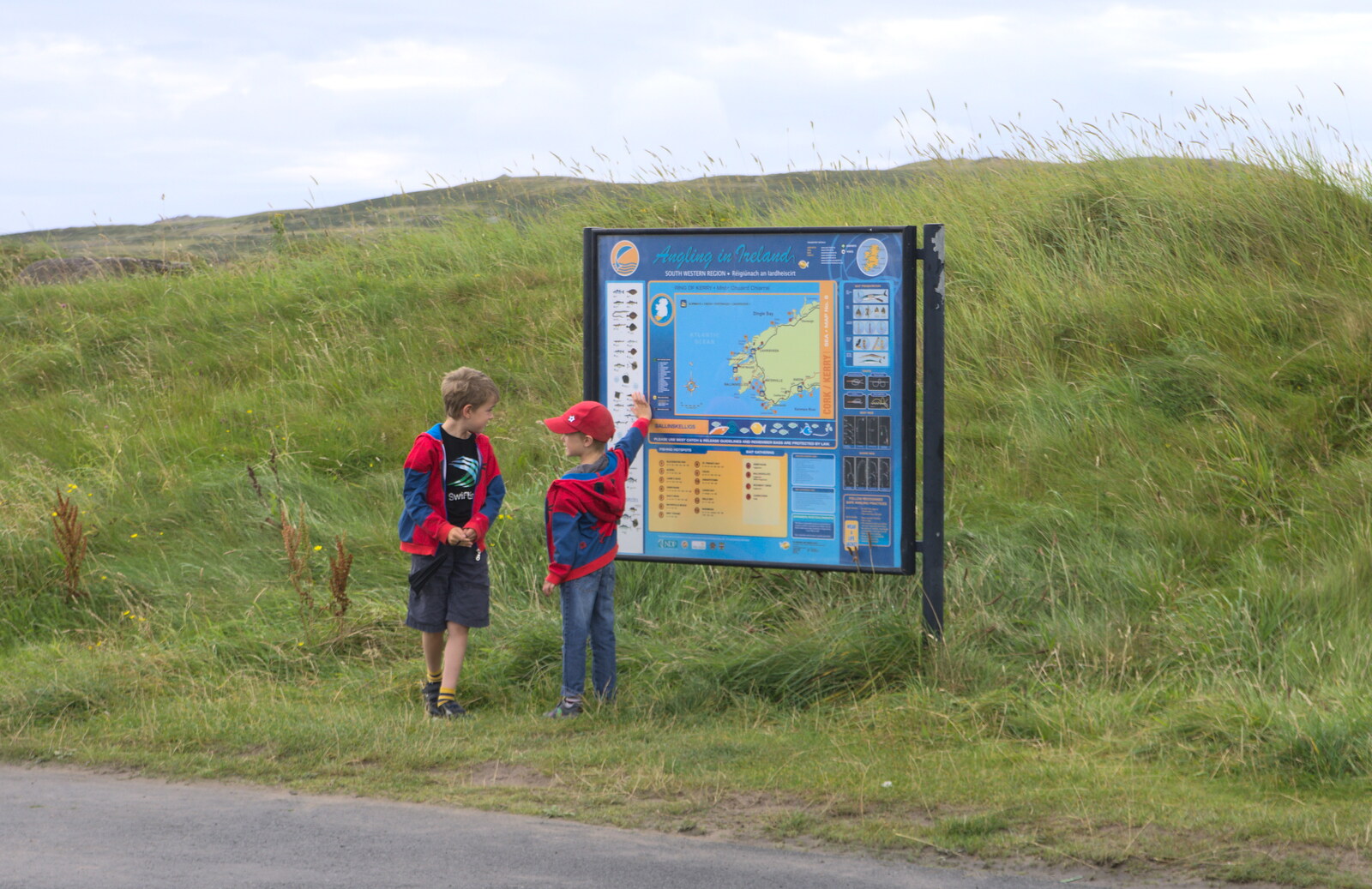 The boys look at a sign about fishing from Baile an Sceilg to An tSnaidhme, Co. Kerry, Ireland - 31st July 2017