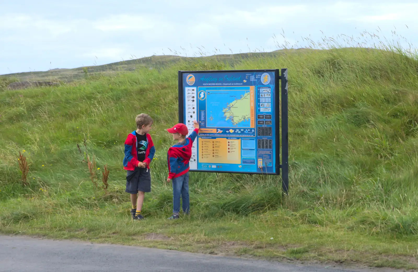 The boys look at a sign about fishing, from Baile an Sceilg to An tSnaidhme, Co. Kerry, Ireland - 31st July 2017