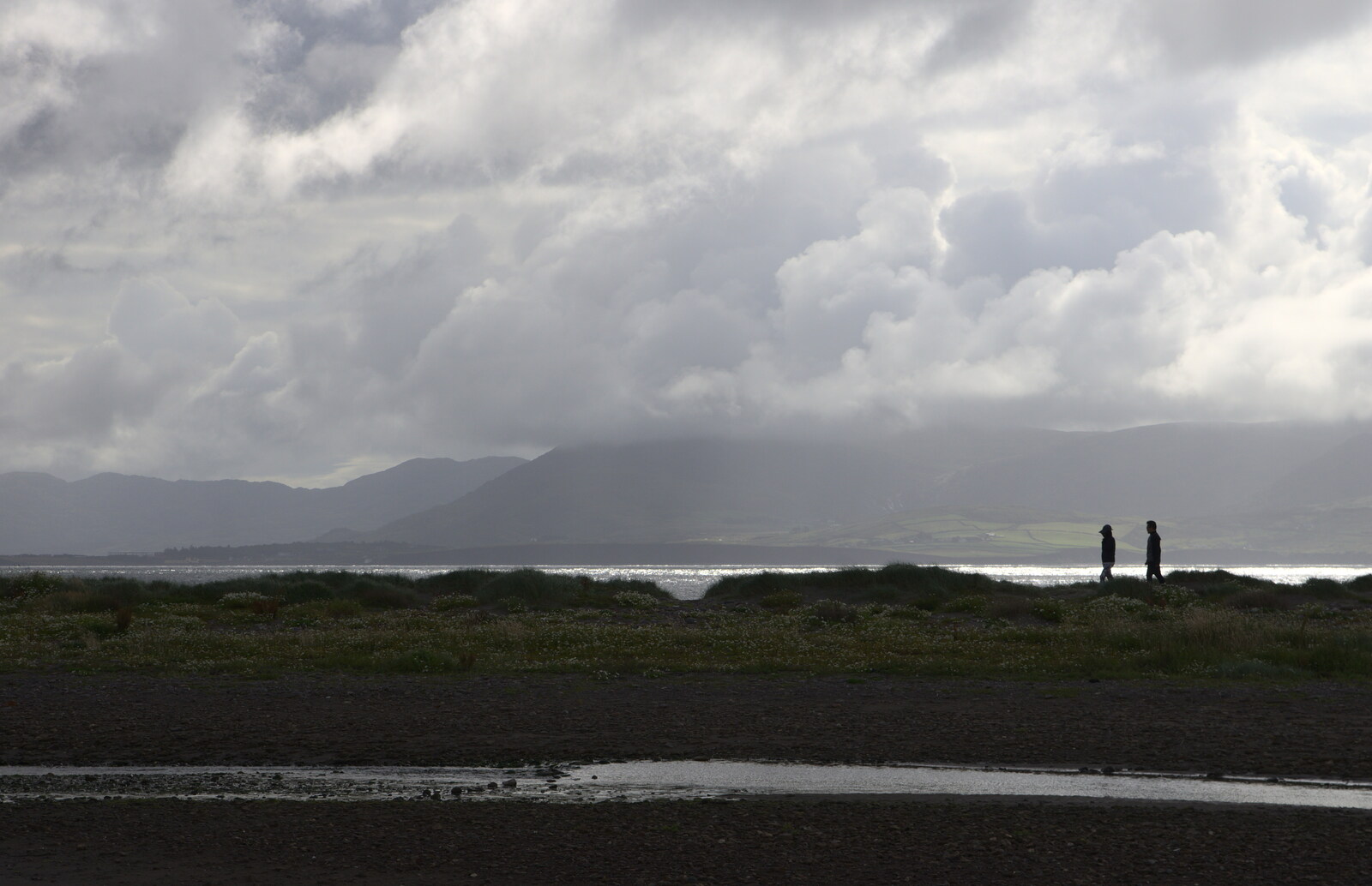 Two people walk on the spit from Baile an Sceilg to An tSnaidhme, Co. Kerry, Ireland - 31st July 2017