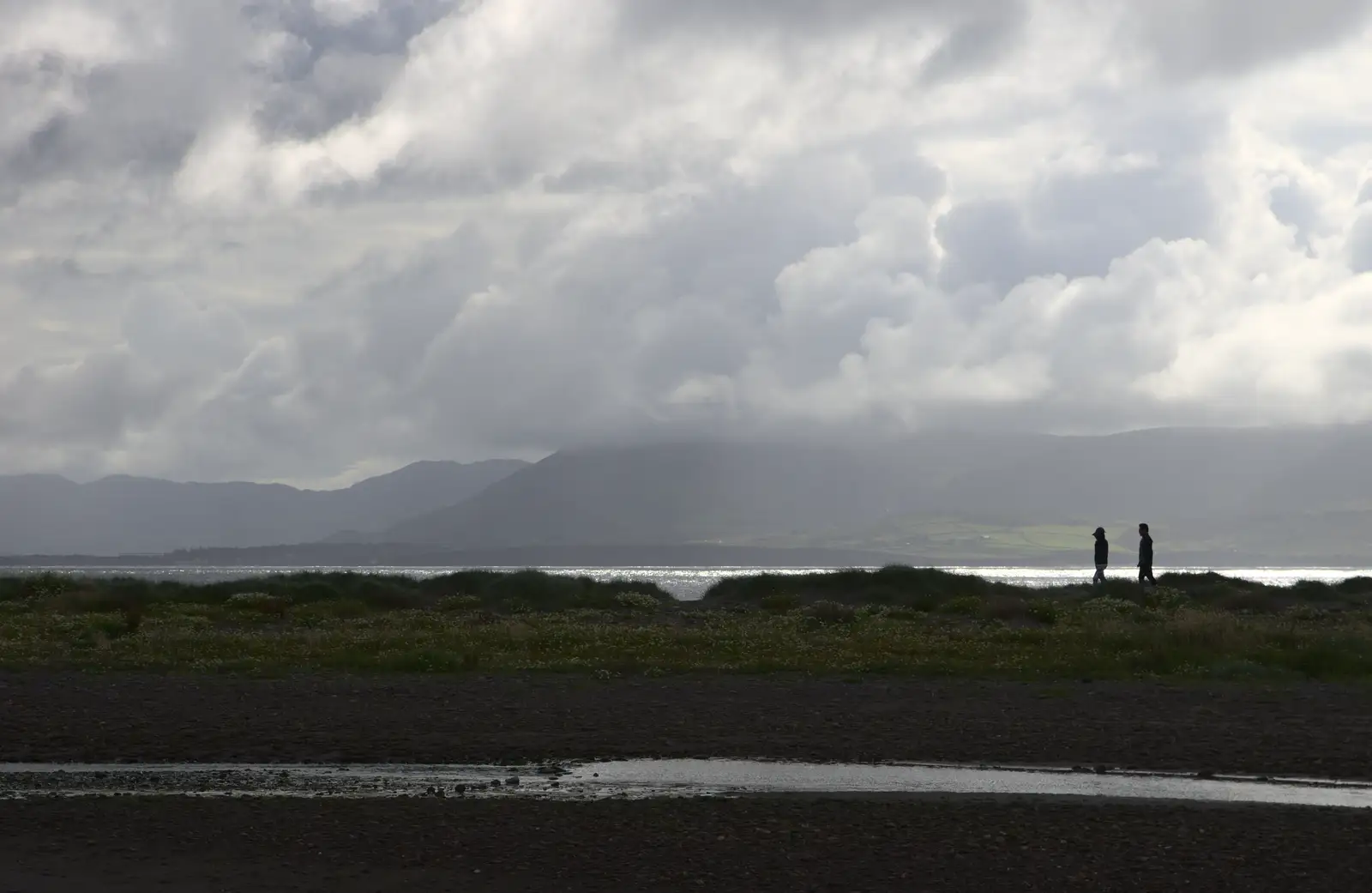 Two people walk on the spit, from Baile an Sceilg to An tSnaidhme, Co. Kerry, Ireland - 31st July 2017