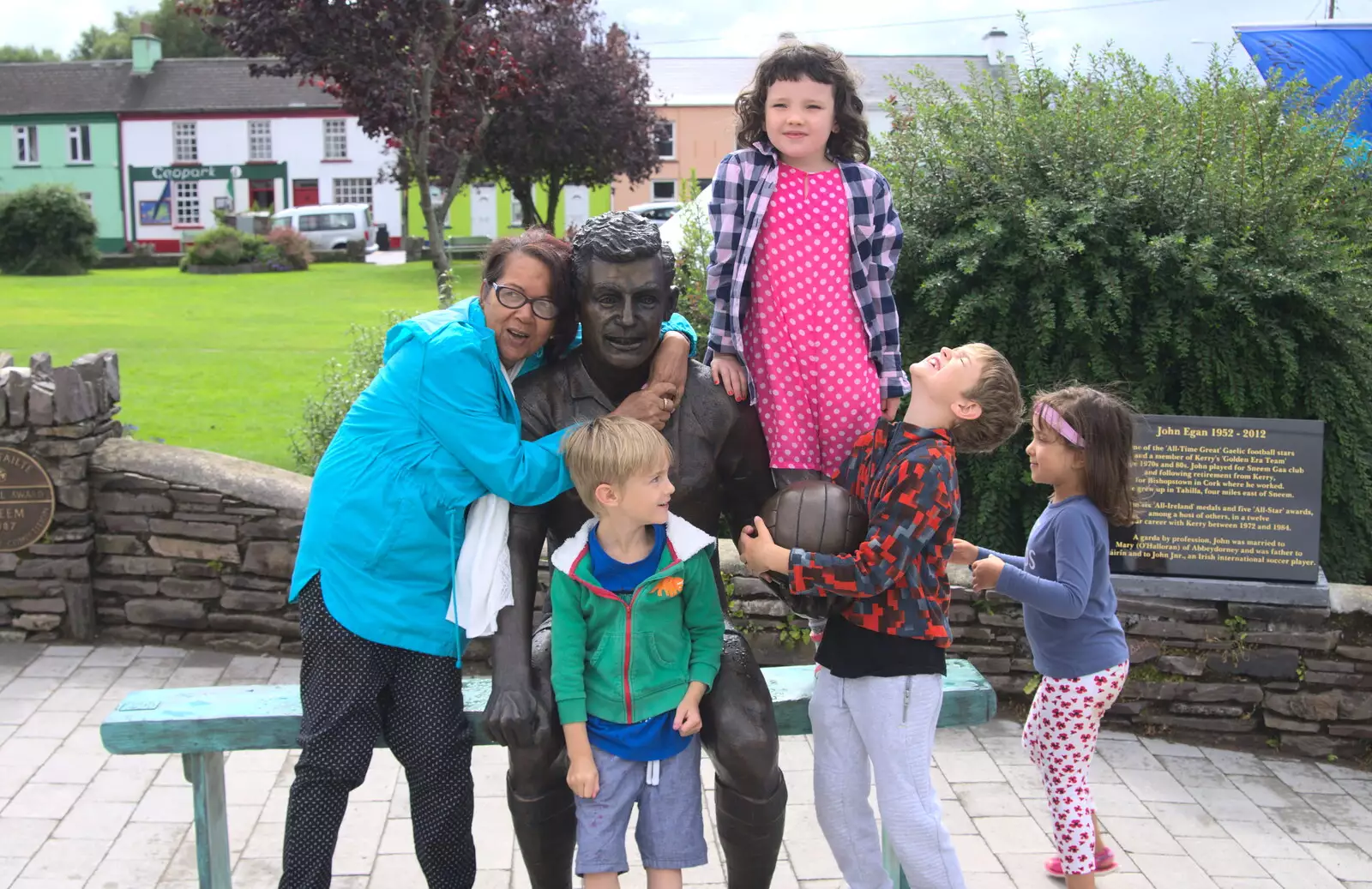 Harryanna's mum hangs on a statue of John Egan, from In The Sneem, An tSnaidhm, Kerry, Ireland - 1st August 2017