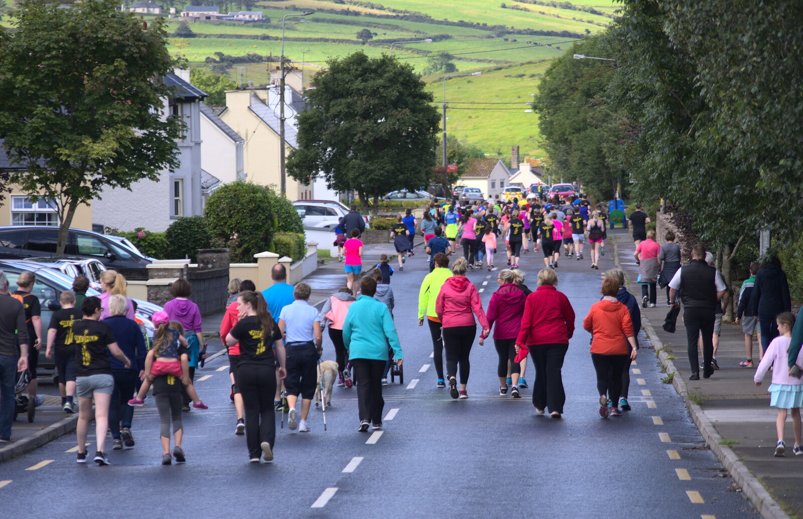 The runners and tag-alongs head off up the main road from The Annascaul 10k Run, Abha na Scáil, Kerry, Ireland - 5th August 2017