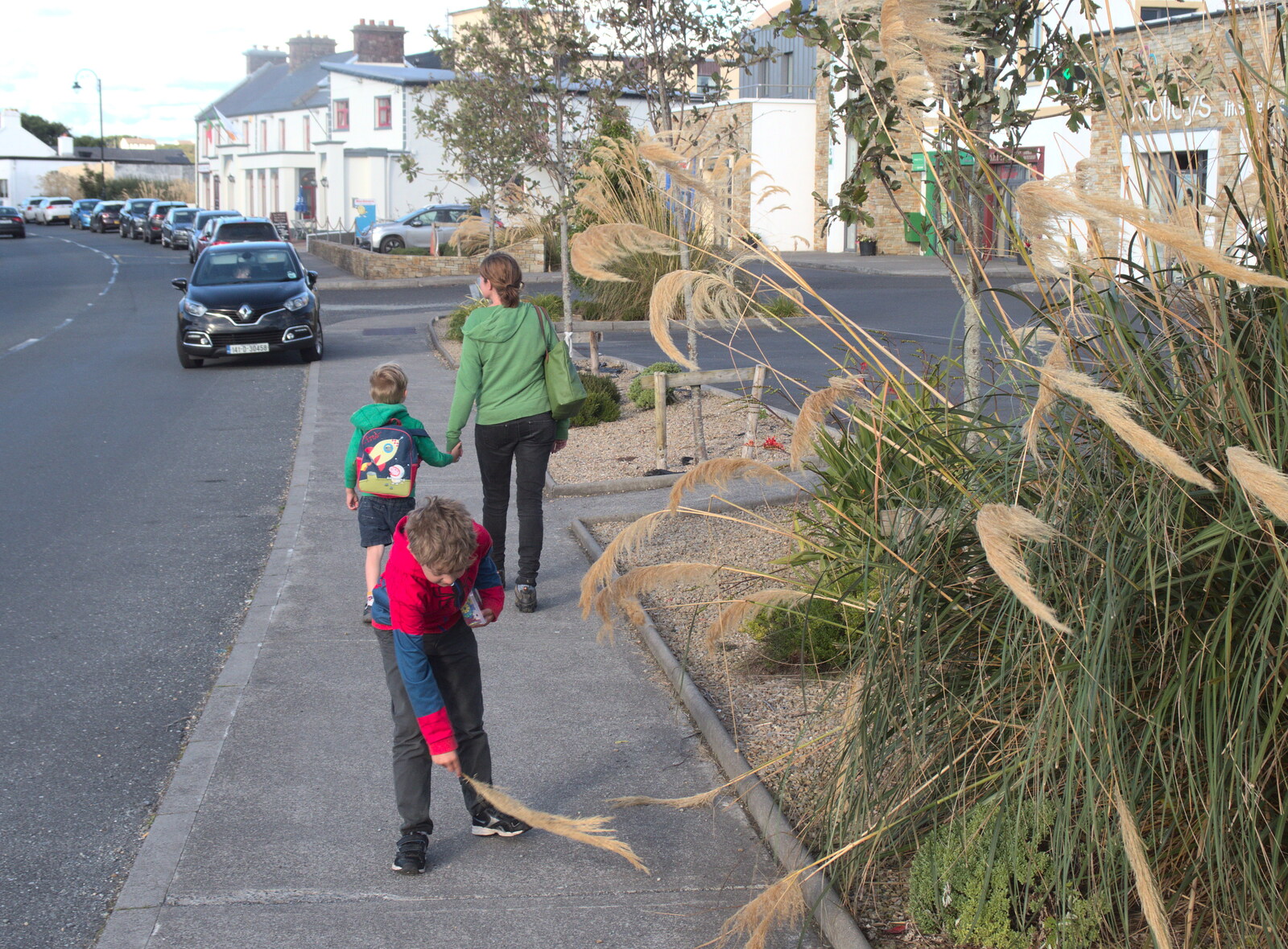 Fred sweeps the pavement with some pampas grass from Surfing Achill Island, Oileán Acla, Maigh Eo, Ireland - 8th August 2017