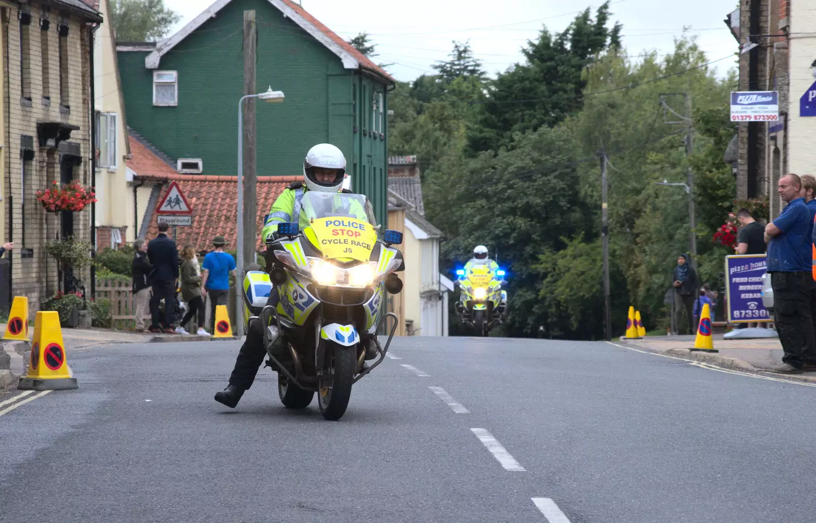 More motorbikes appear up the hill, from The Tour of Britain Does Eye, Suffolk - 8th September 2017