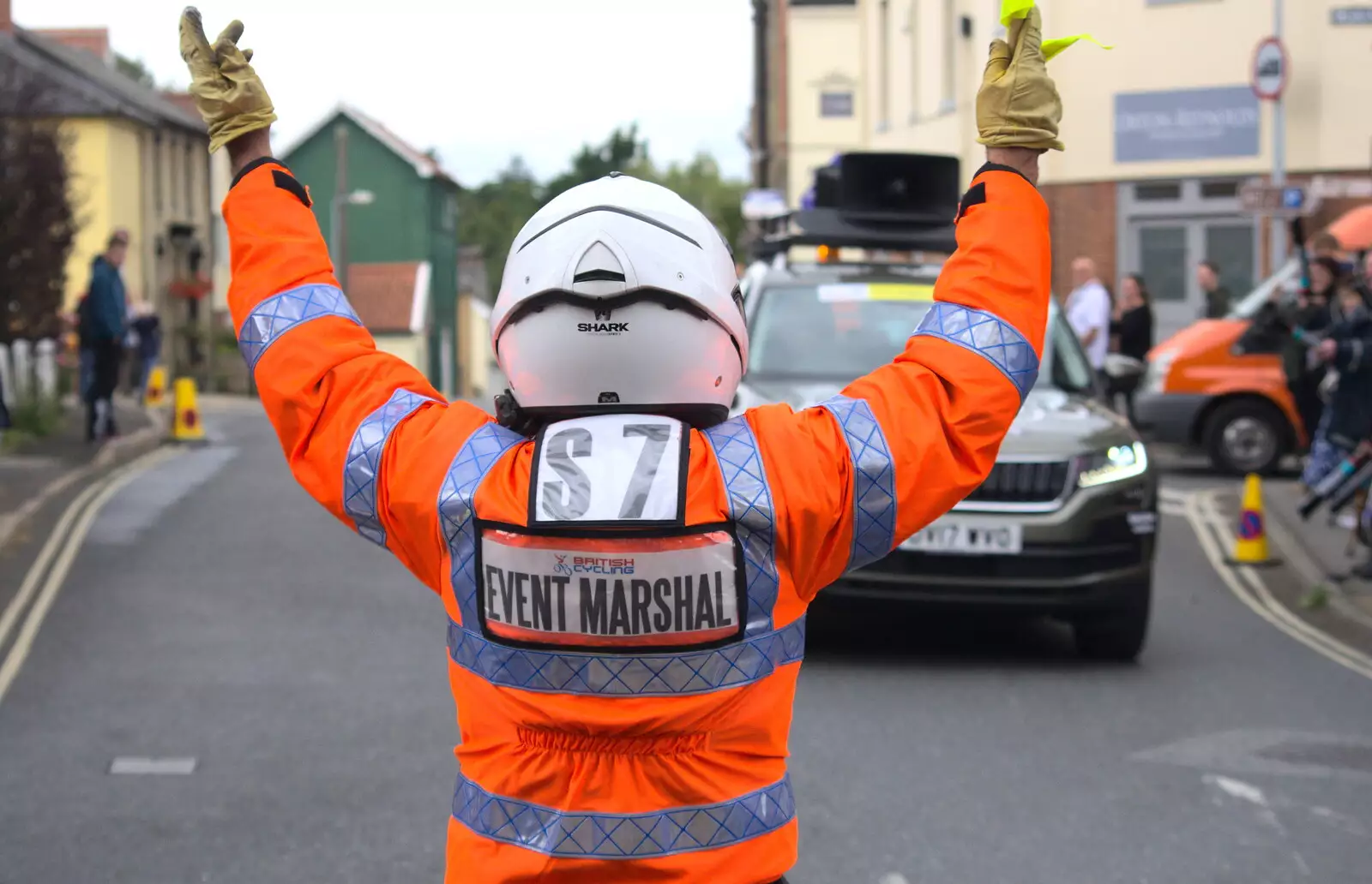 An event marshall directs the radio car, from The Tour of Britain Does Eye, Suffolk - 8th September 2017