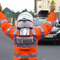 An event marshall directs the radio car, The Tour of Britain Does Eye, Suffolk - 8th September 2017