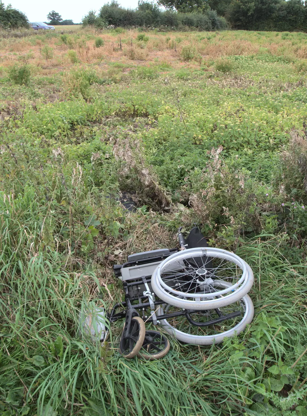 There's an abandoned wheelchair in a field, from A Summer Fete, Palgrave, Suffolk - 10th September 2017