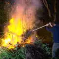 Alex gives the fire a poke, Alex and Anita's Fireworks, Cemetery House, Eye, Suffolk - 5th November 2017