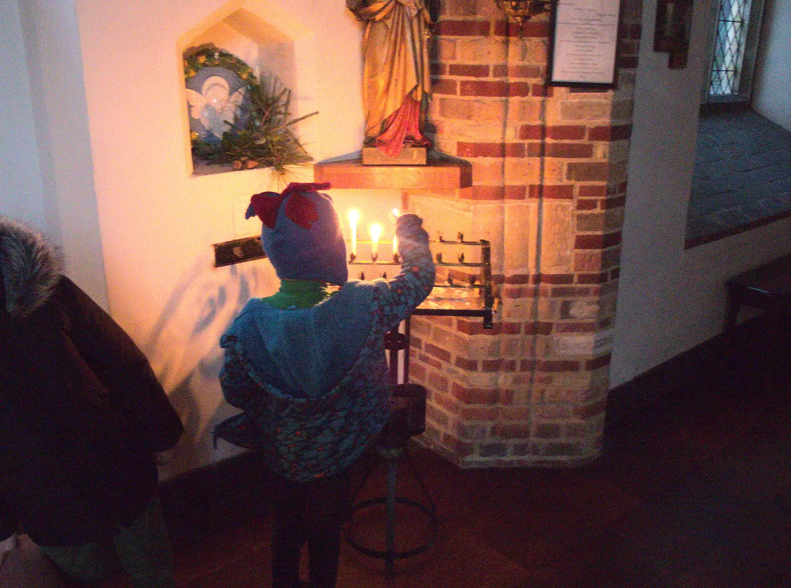 Harry lights a candle in St. Julian's Church, from A Trip to the Cinema, Norwich, Norfolk - 3rd December 2017