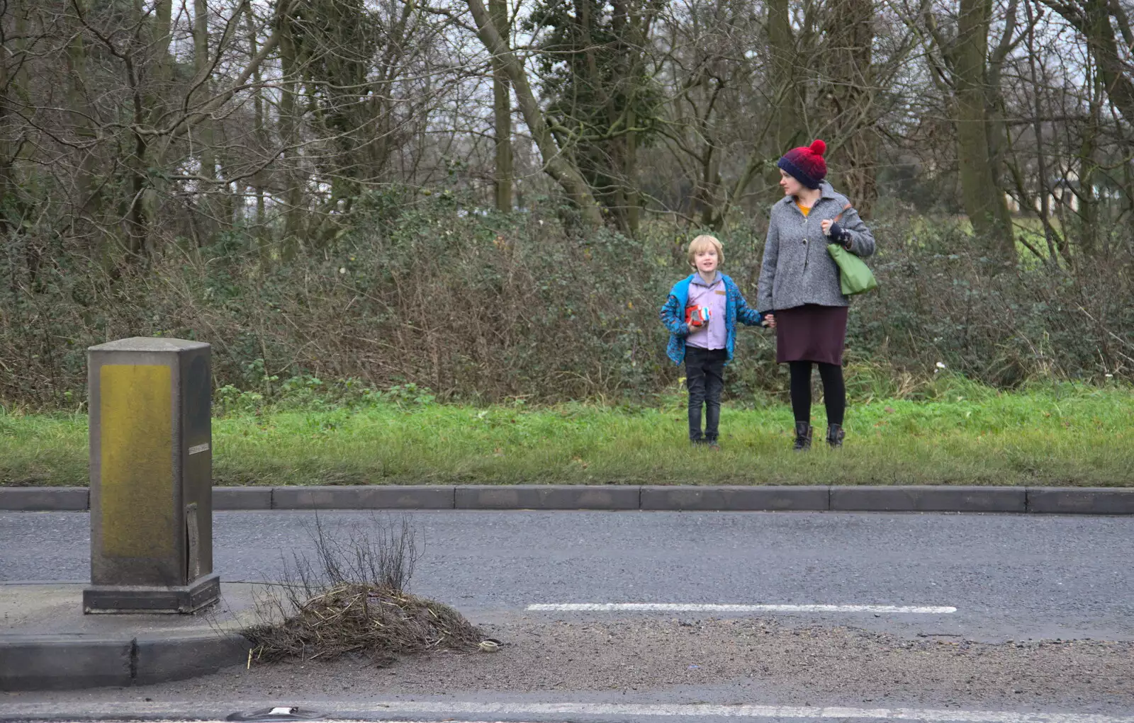 Harry and Isobel wait to cross the road, from Christmas Day and The Swan Inn, Brome, Suffolk - 25th December 2017