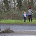 Christmas Day and The Swan Inn, Brome, Suffolk - 25th December 2017, Harry and Isobel wait to cross the road
