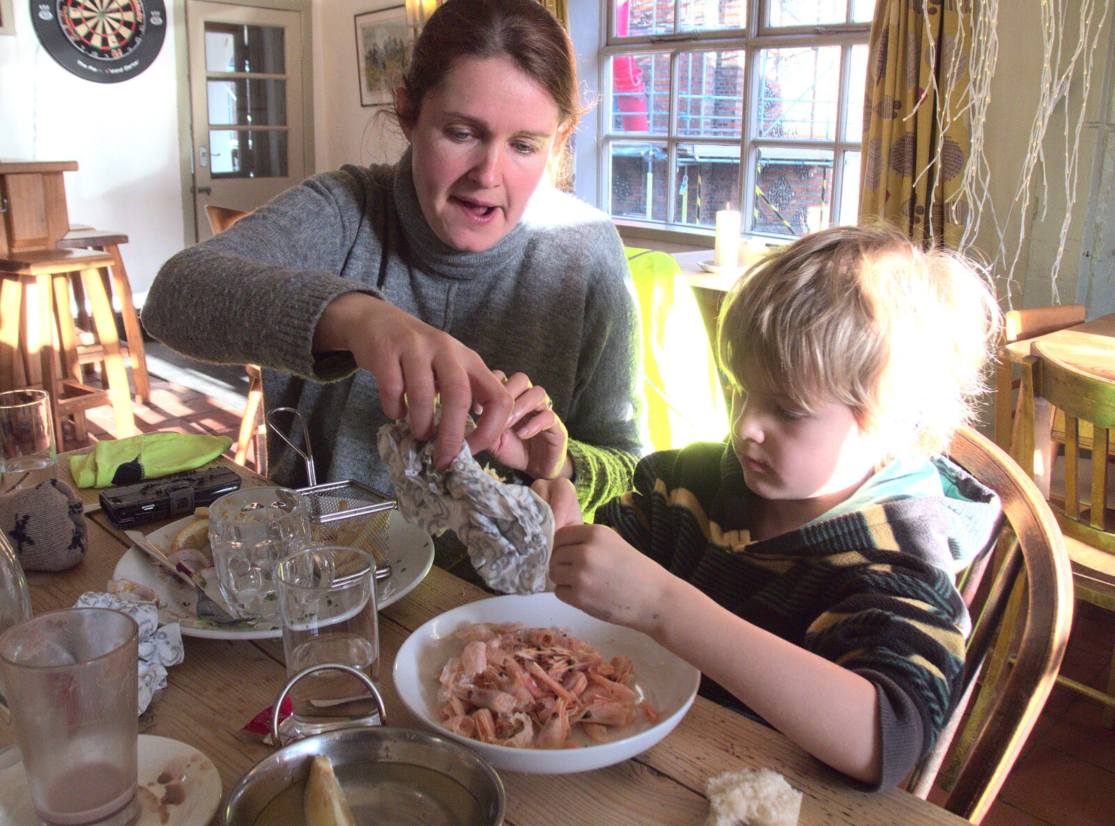 Isobel helps harry with prawn shells from Boxing Day in the Queen's Head, Eye, Suffolk - 26th December 2017