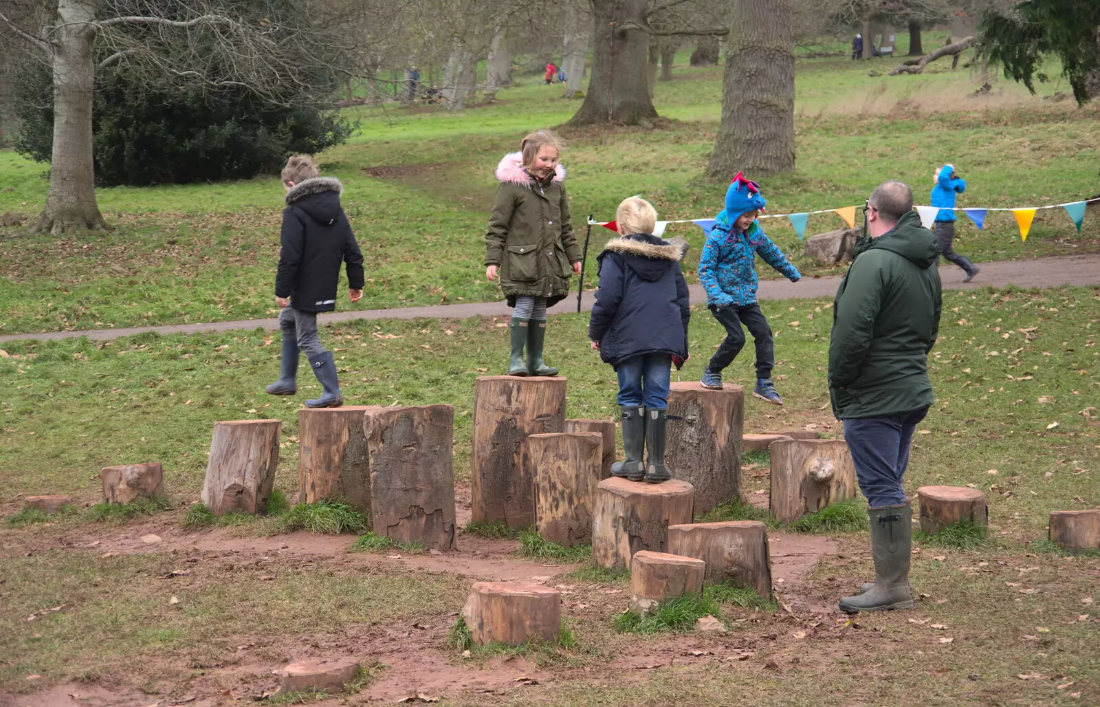 Fred and Harry run around on tree stumps, from Killerton House, Broadclyst, Devon - 30th December 2017