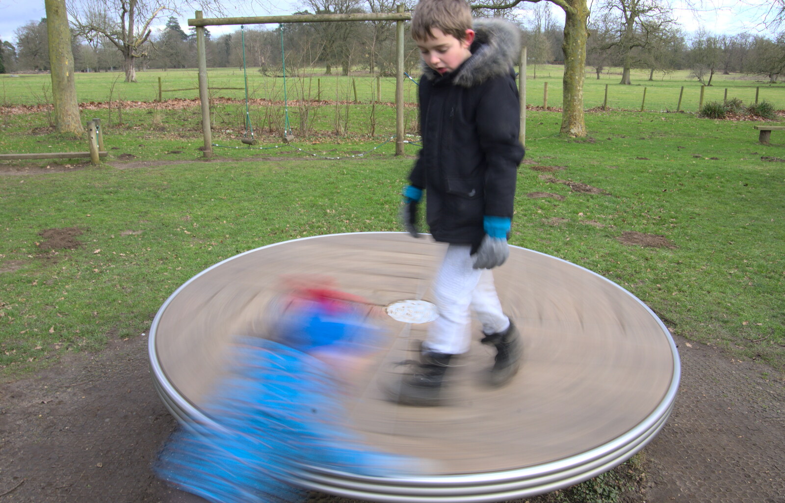 Harry's a blur as he spins the roundabout from A Return to Thornham Walks, Suffolk - 4th February 2018