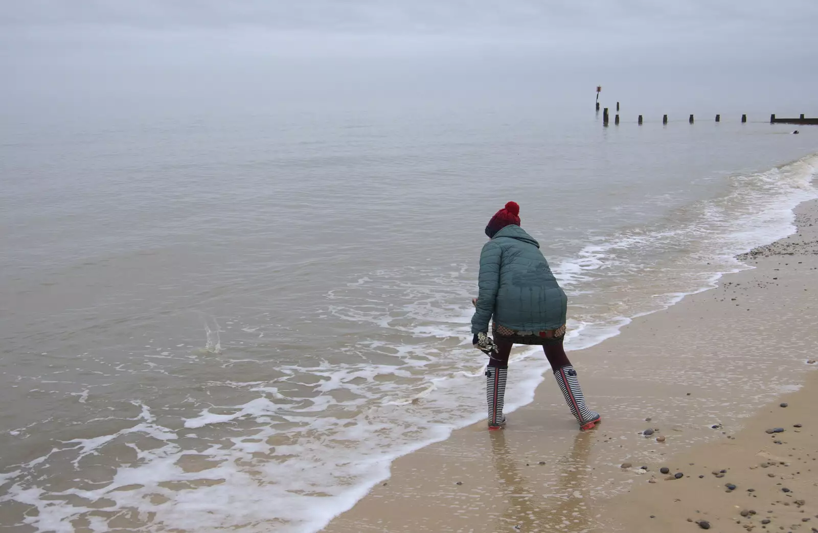 Isobel skims a stone, from A Southwold Car Picnic, Southwold, Suffolk - 11th March 2018