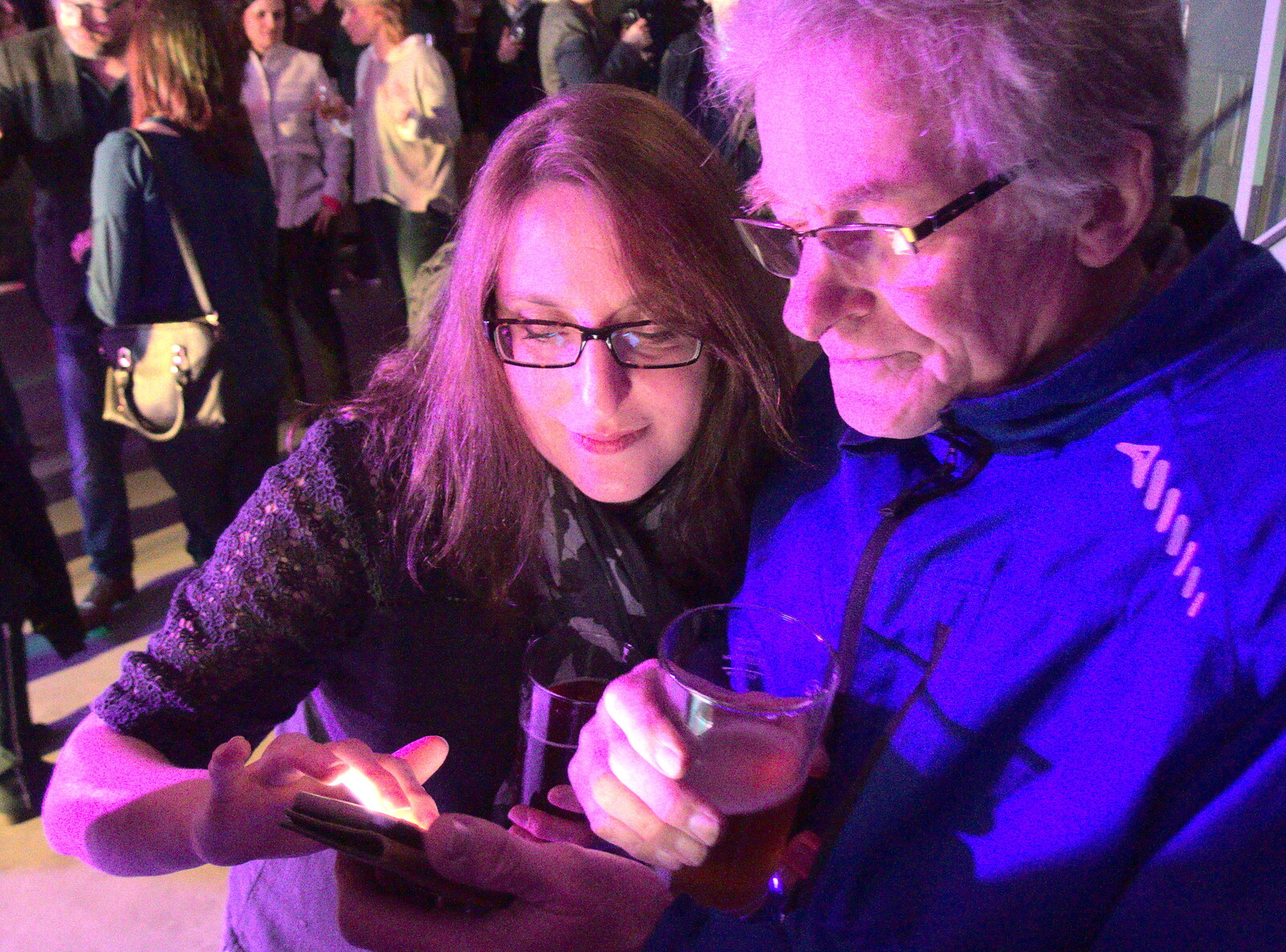 Suey looks at something on Marticle's phone from Elvis Lives! (in a Brewery), Station 119, Eye, Suffolk - 29th March 2018