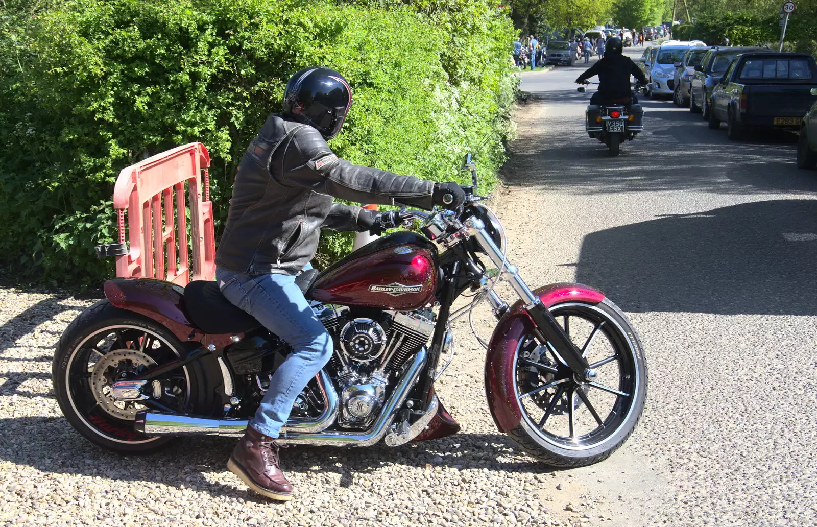 A biker on a Harley rides off, from Beer, Bikes and Bands, Burston Crown, Burston, Norfolk - 6th May 2018