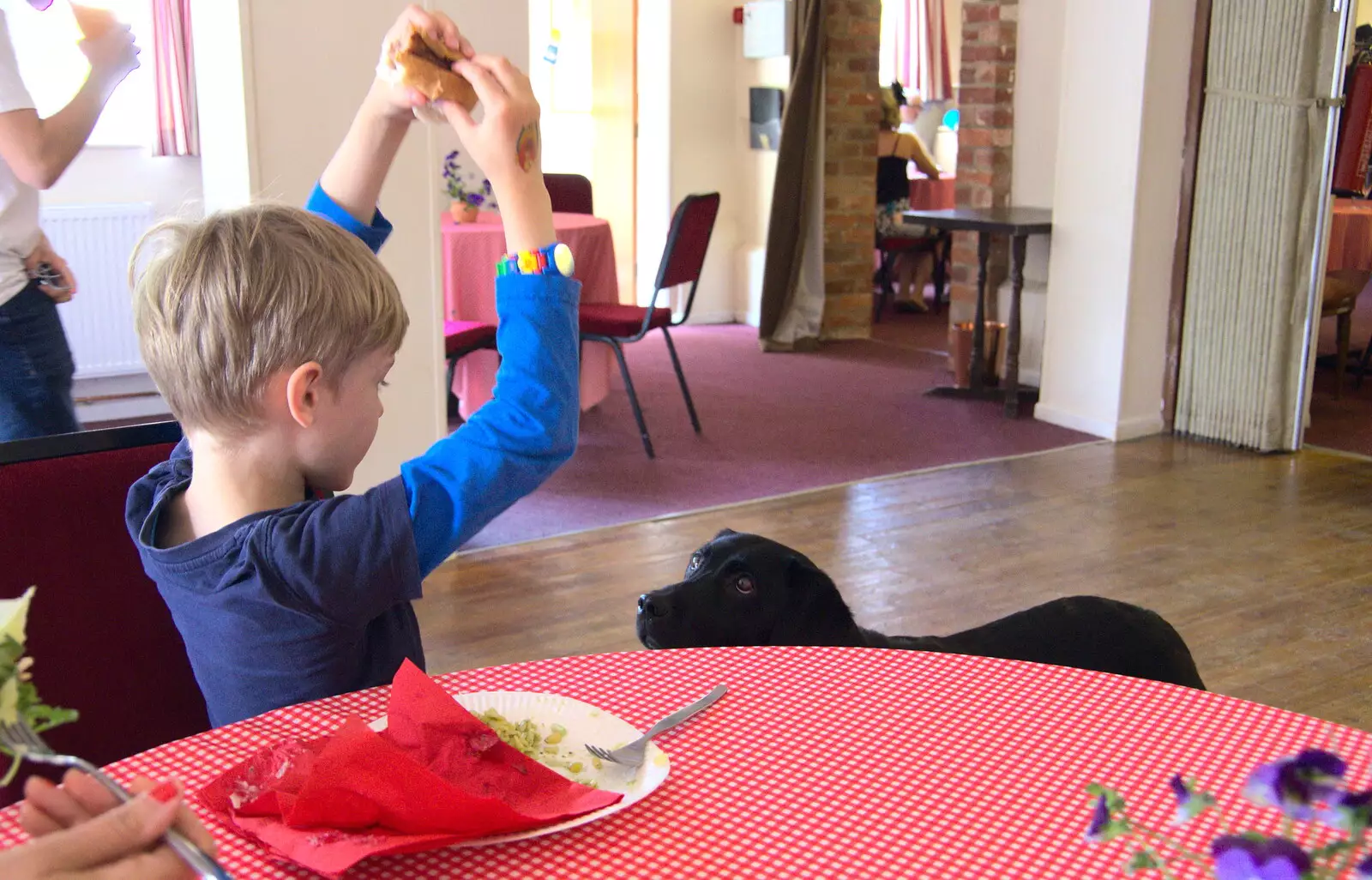 Harry hides his sausage from a keen Labrador, from A Right Royal Wedding at the Village Hall, Brome, Suffolk - 19th May 2018