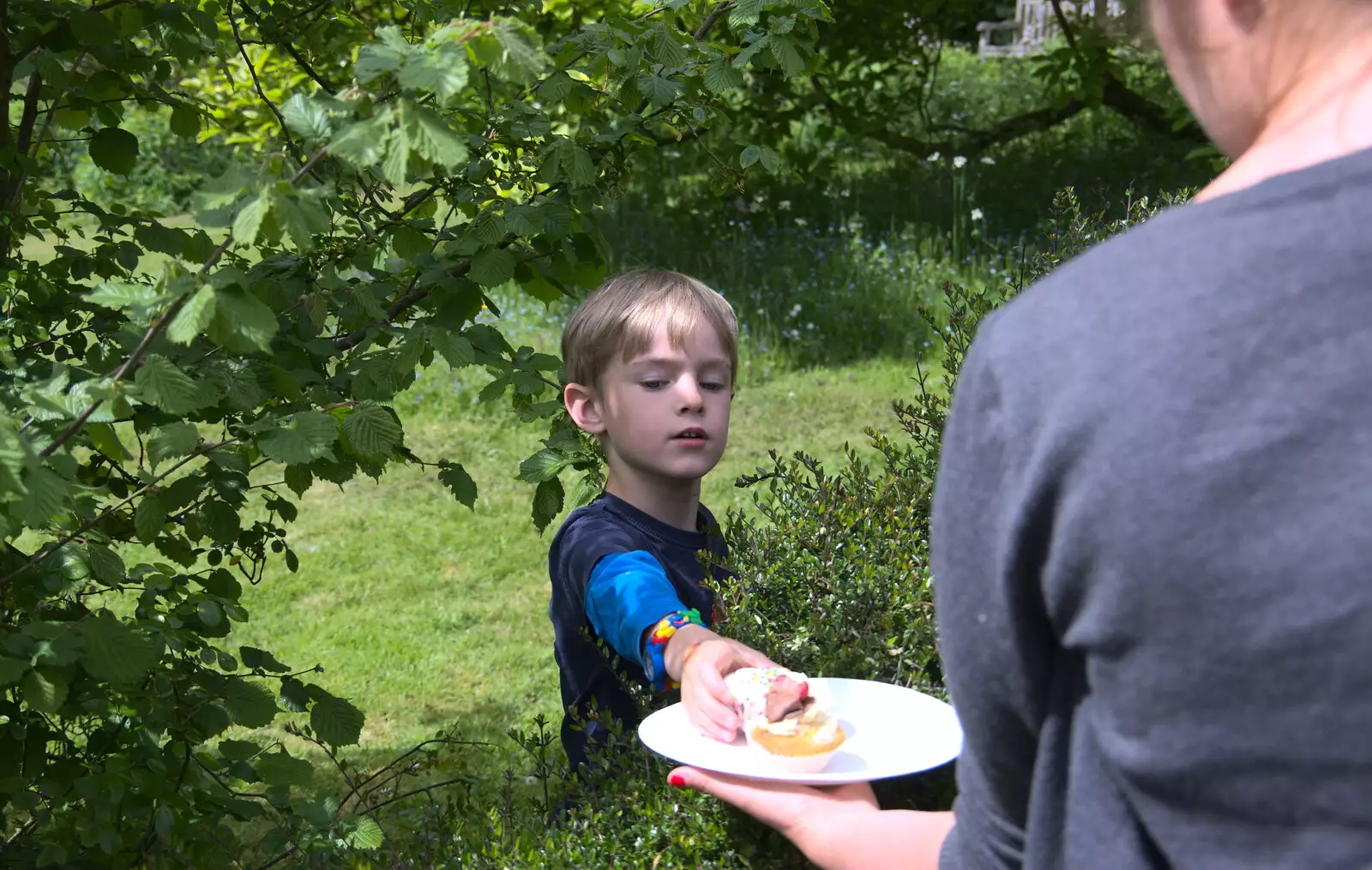 Harry appears through the hedge to claim his cake, from A Right Royal Wedding at the Village Hall, Brome, Suffolk - 19th May 2018