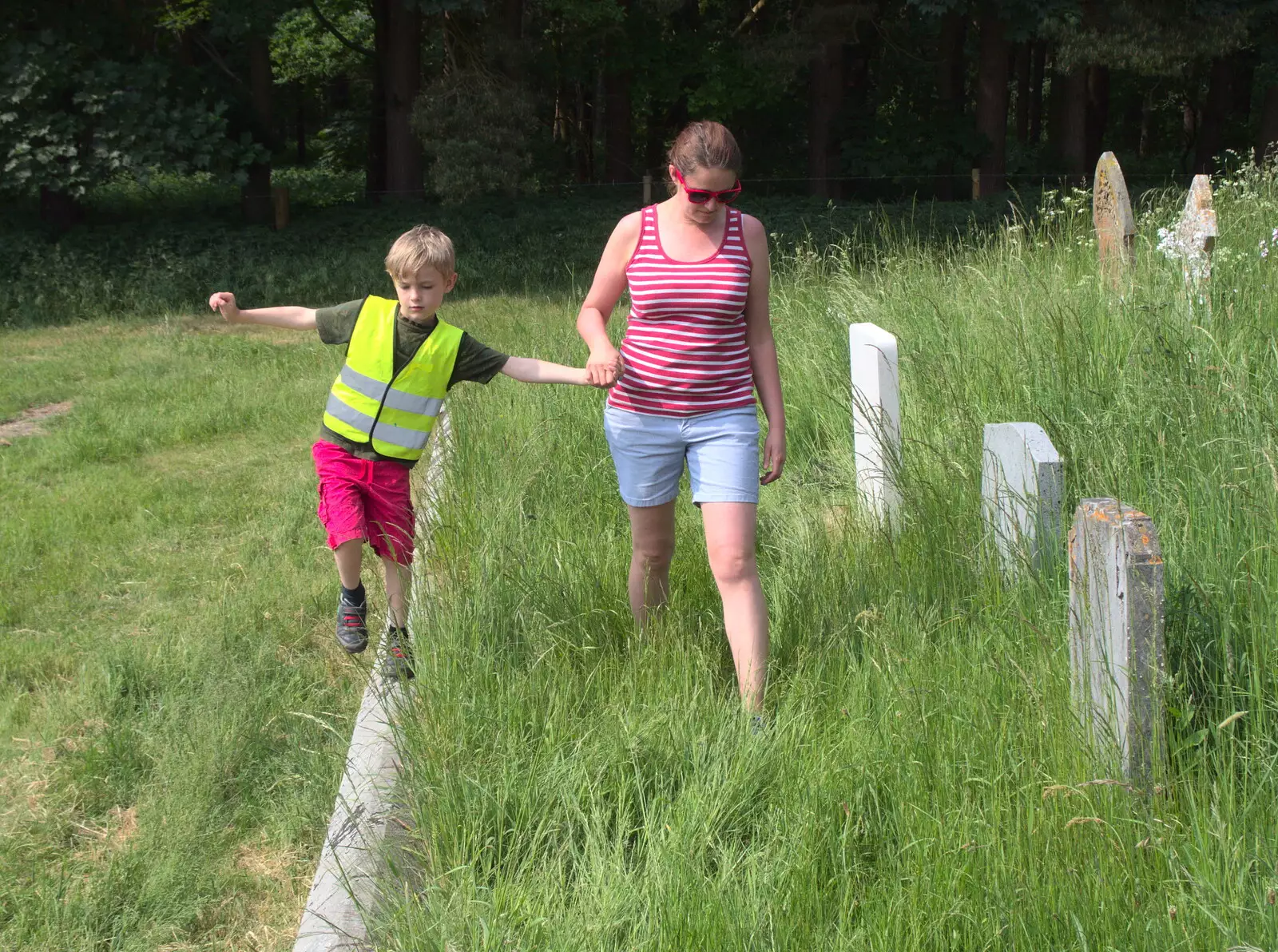 Harry walks on a wall, as we explore the graveyard, from Dower House Camping, West Harling, Norfolk - 27th May 2018