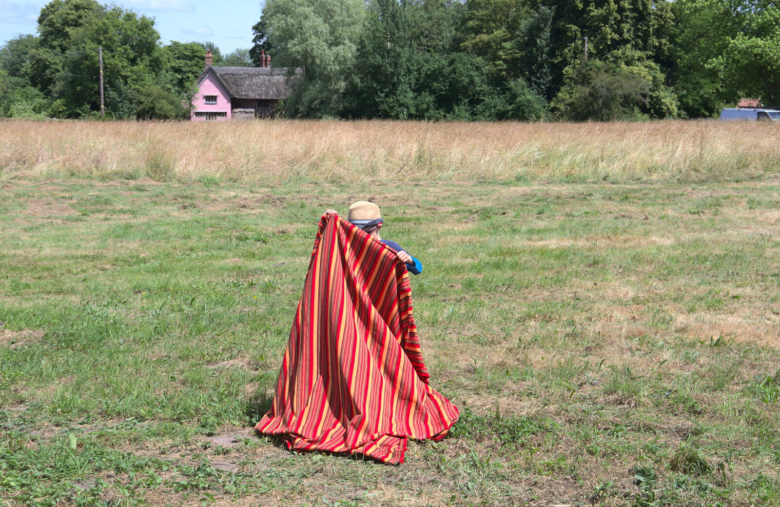 Harry sets up a blanket on the green from A Village Hog Roast, Little Green, Thrandeston, Suffolk - 24th June 2018