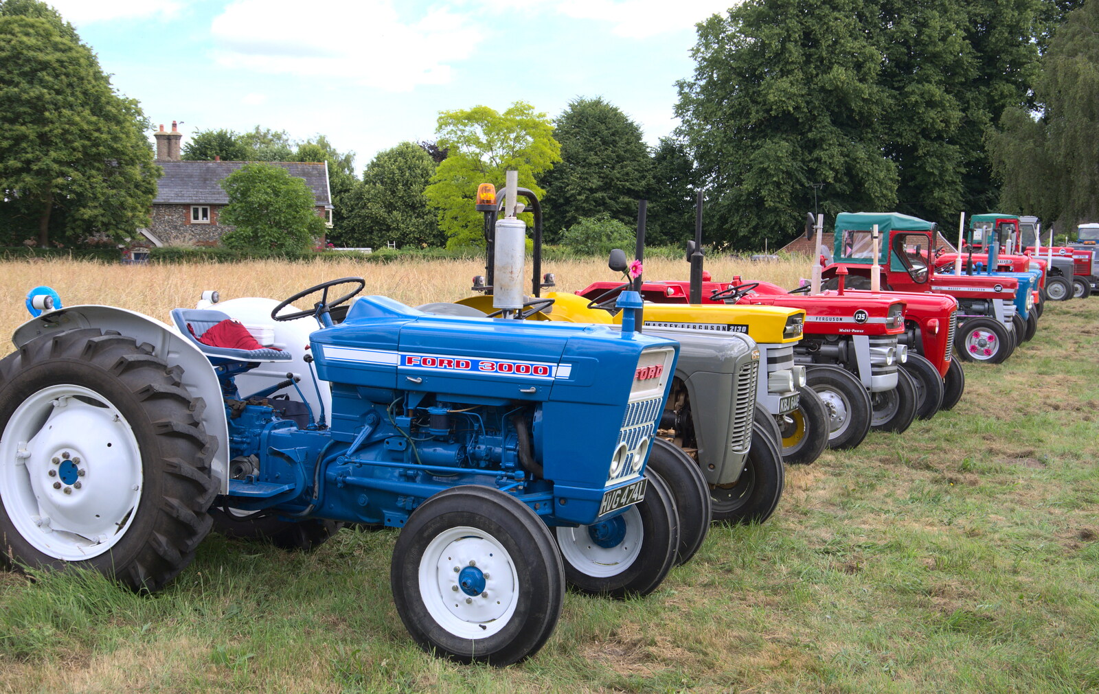 A line of tractors from A Village Hog Roast, Little Green, Thrandeston, Suffolk - 24th June 2018