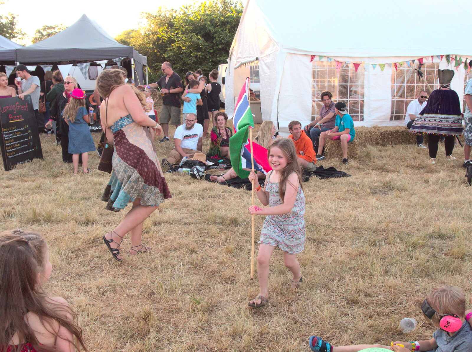 A girl runs off with the flag from WoW Festival, Burston, Norfolk - 29th June - 1st July 2018