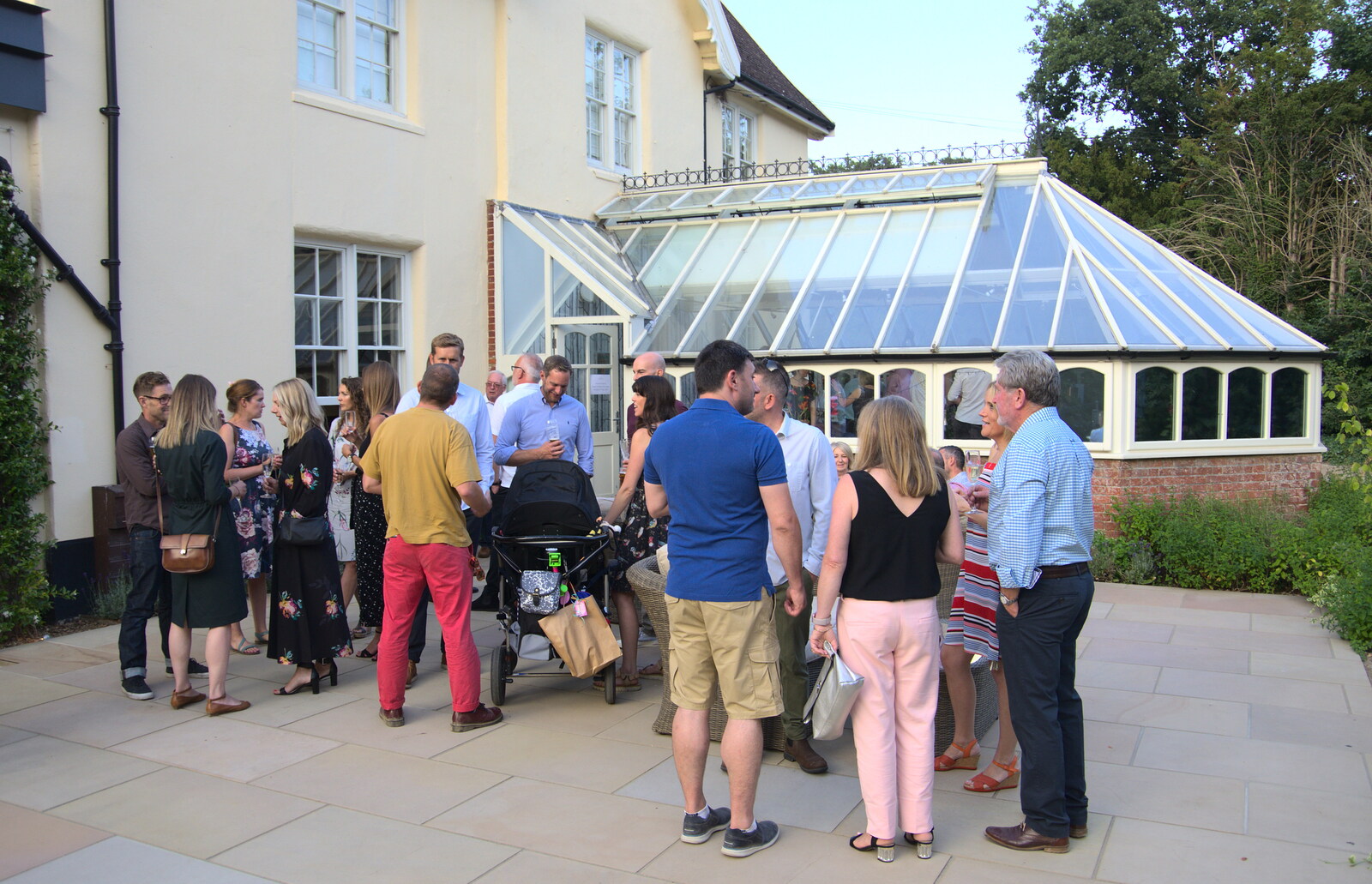 Guests spill out onto the patio from An Oaksmere Party, Brome, Suffolk - 14th July 2018