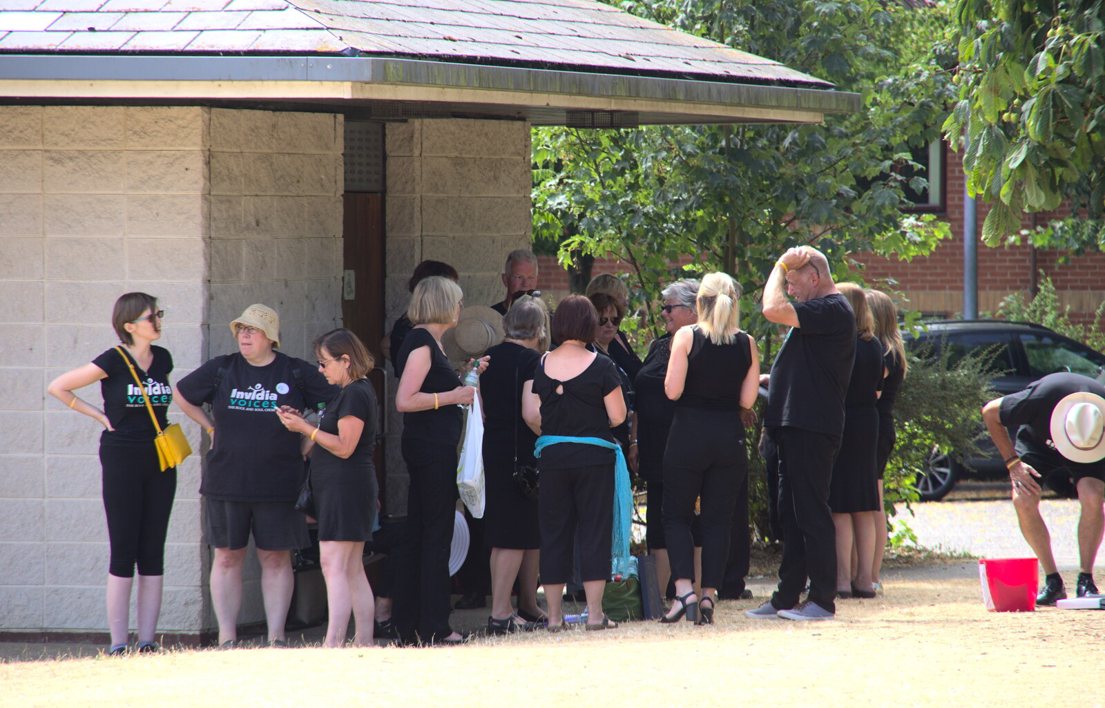 The choir shelters under the roof of the public bogs from Diss Fest, The Park, Diss, Norfolk - 22nd July 2018