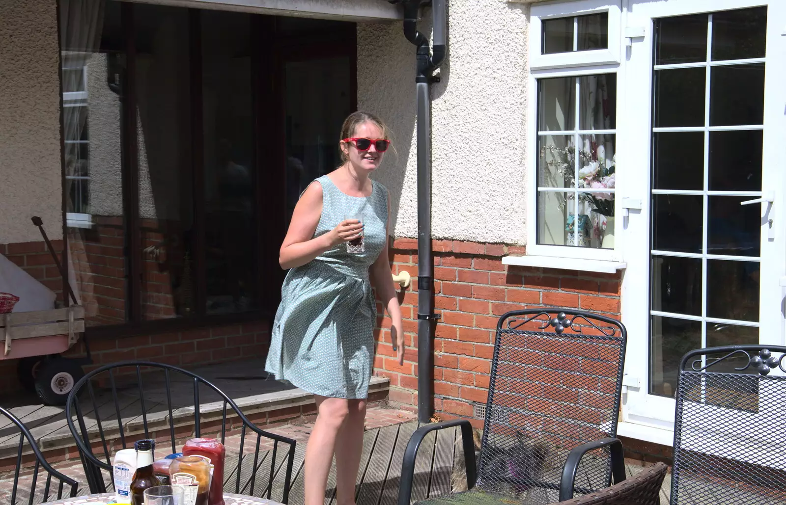 Isobel comes out with a drink, from A Barbeque at Sean's, Walkford, Dorset - 28th July 2018