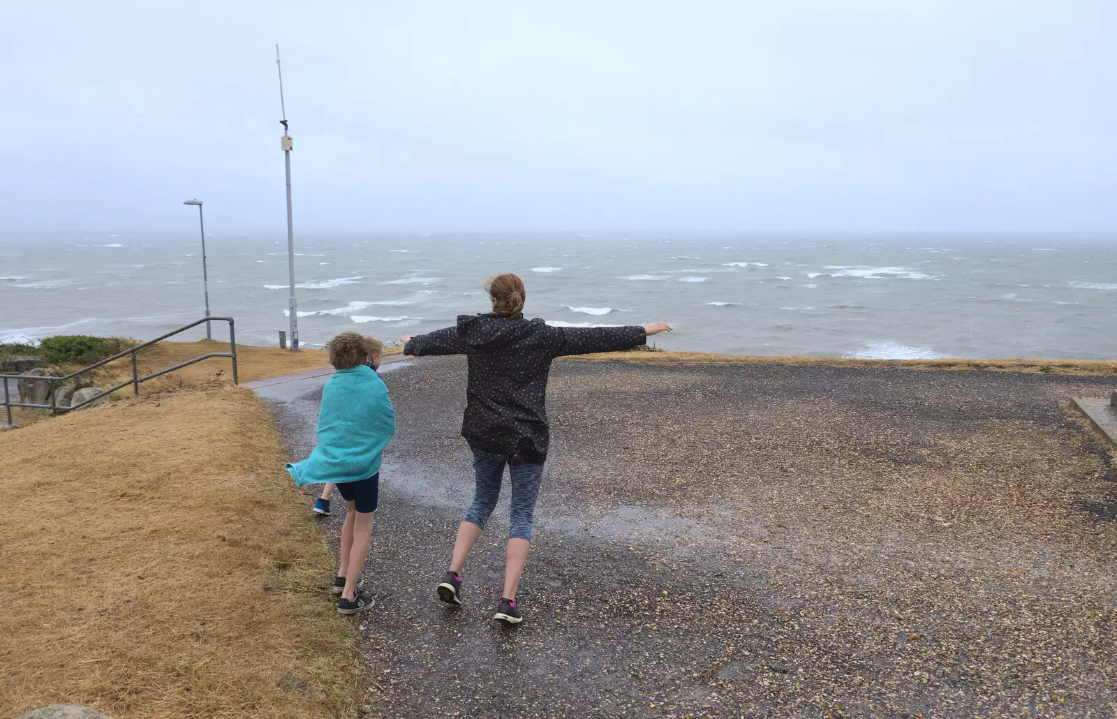 Isobel leans into the wind, from Blustery Beach Trips, Walkford and Highcliffe, Dorset - 29th July 2018